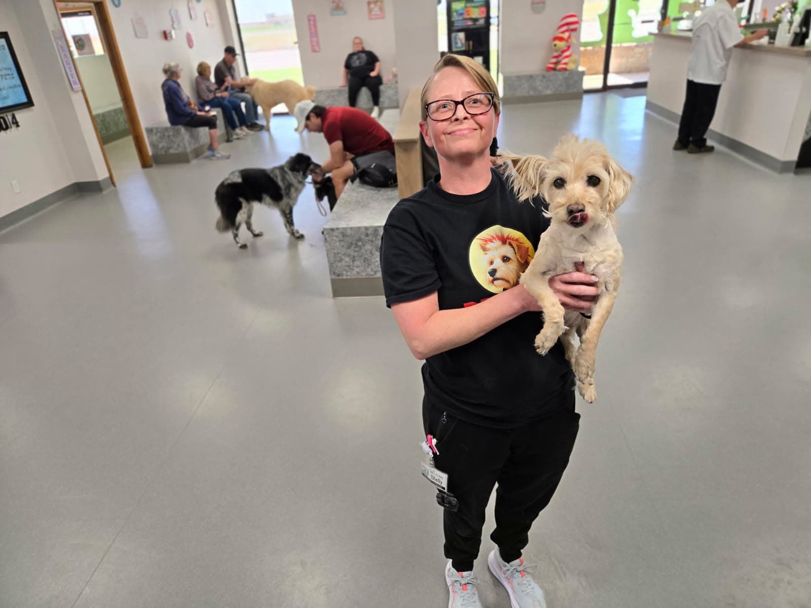 PETS Clinic team member holding a dog inside the clinic